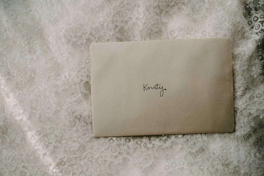 letter to the bride lying on the wedding dress
