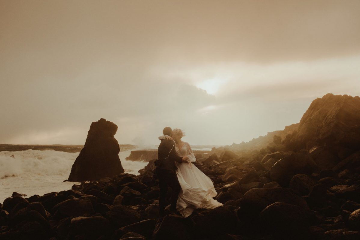 Iceland wedding portrait of a couple posing by the waves