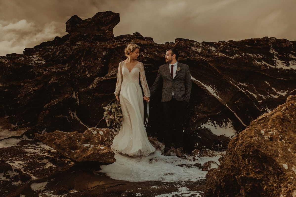 Iceland wedding portrait of a couple posing by rocks