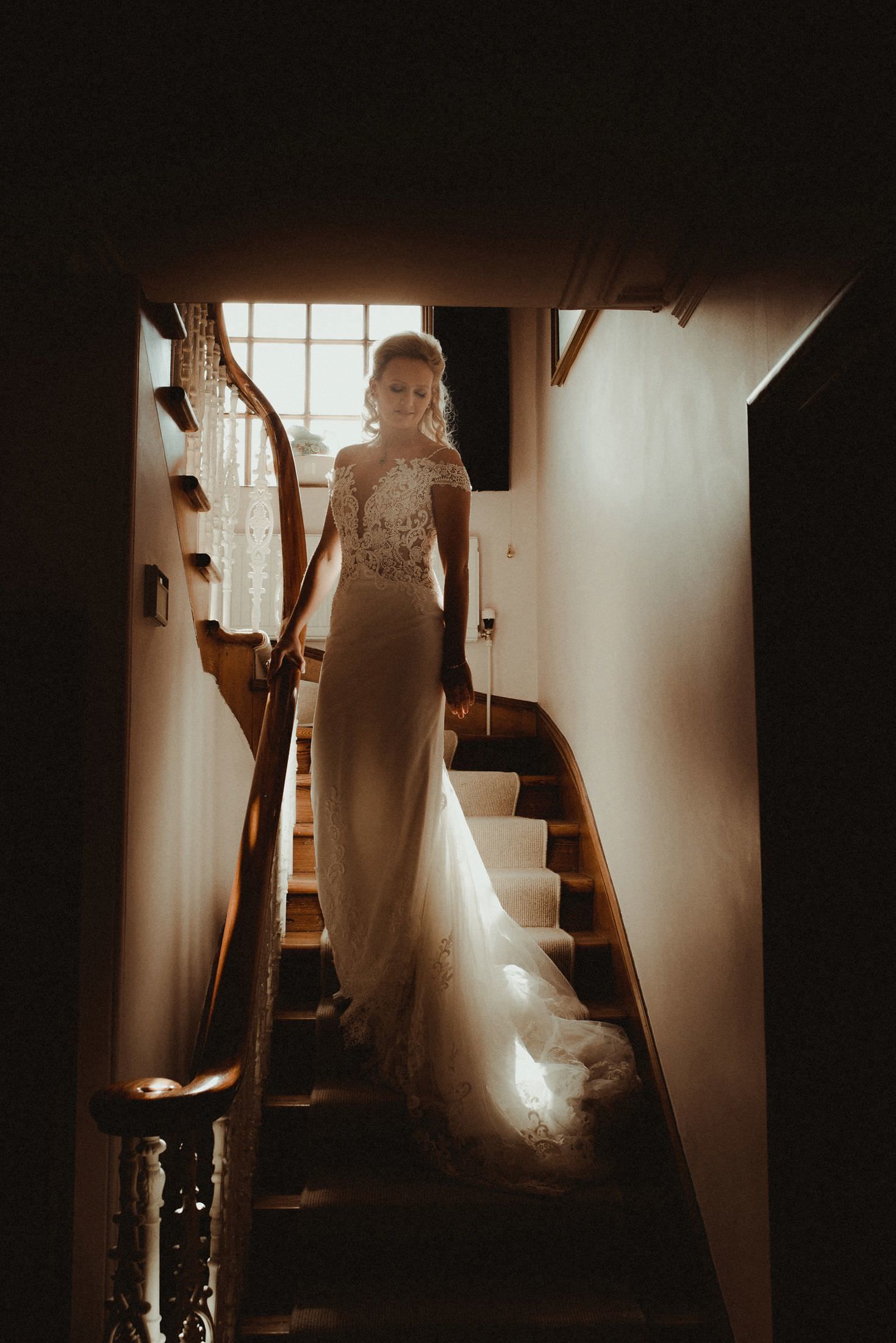 Bride walking down the stairs to go to her wedding at Elsick House